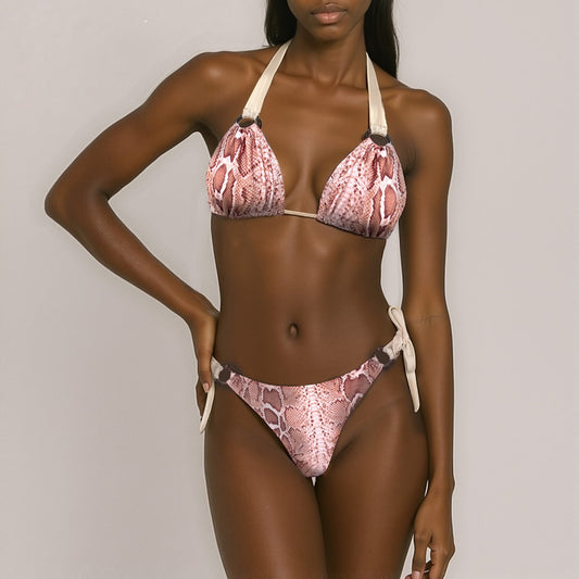 Model wearing a pink snake print bikini against a neutral background