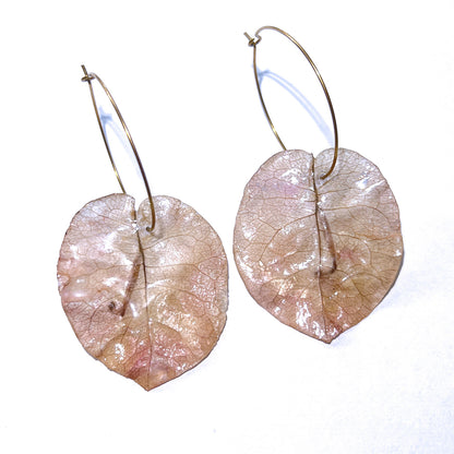 Pair of leaf-shaped earrings on a white background