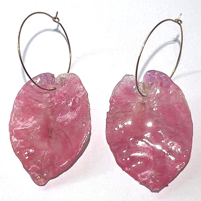 Pink leaf-shaped earrings on a white background