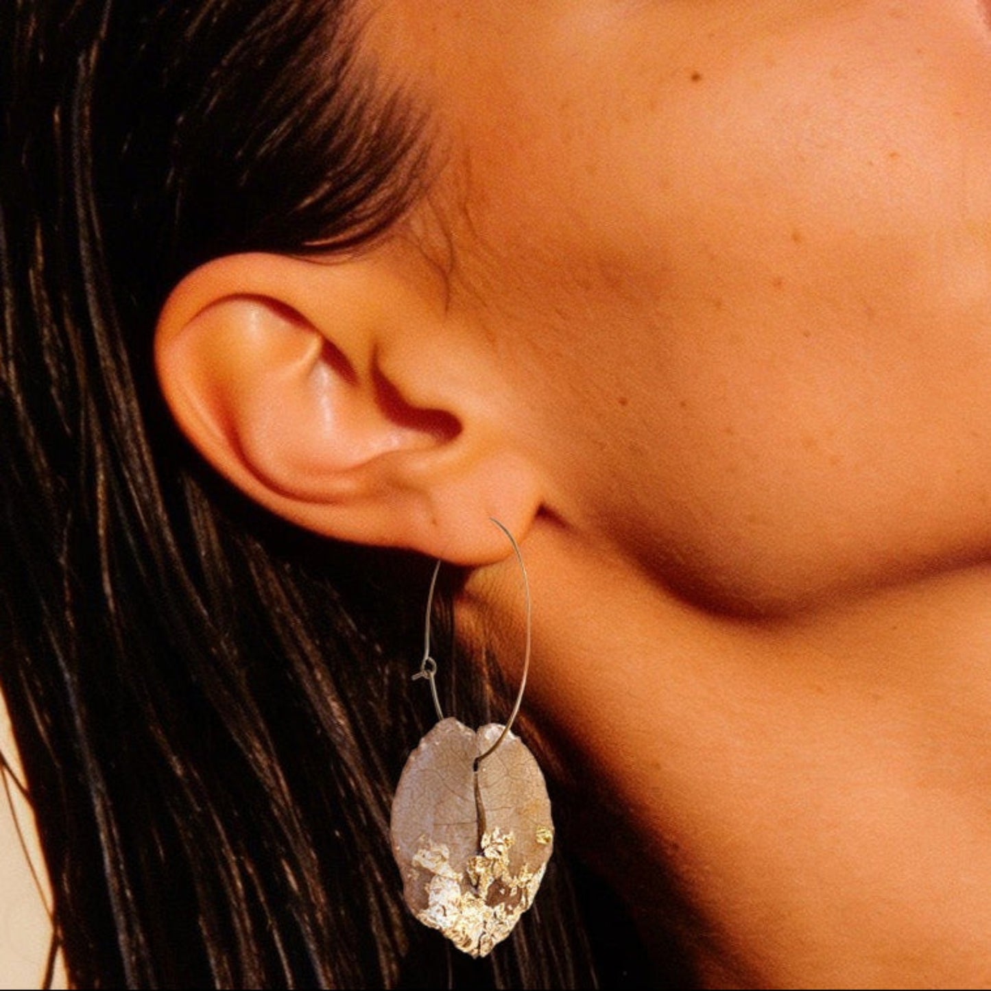 Model wearing tan and gold bougainvillea flower petal earrings - detail shot