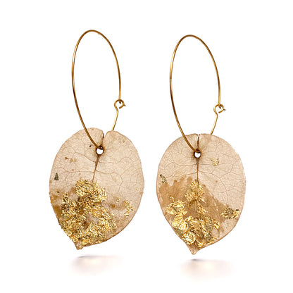 Pair of DEESSA Ibiza earrings with gold leaf detailing on a white background