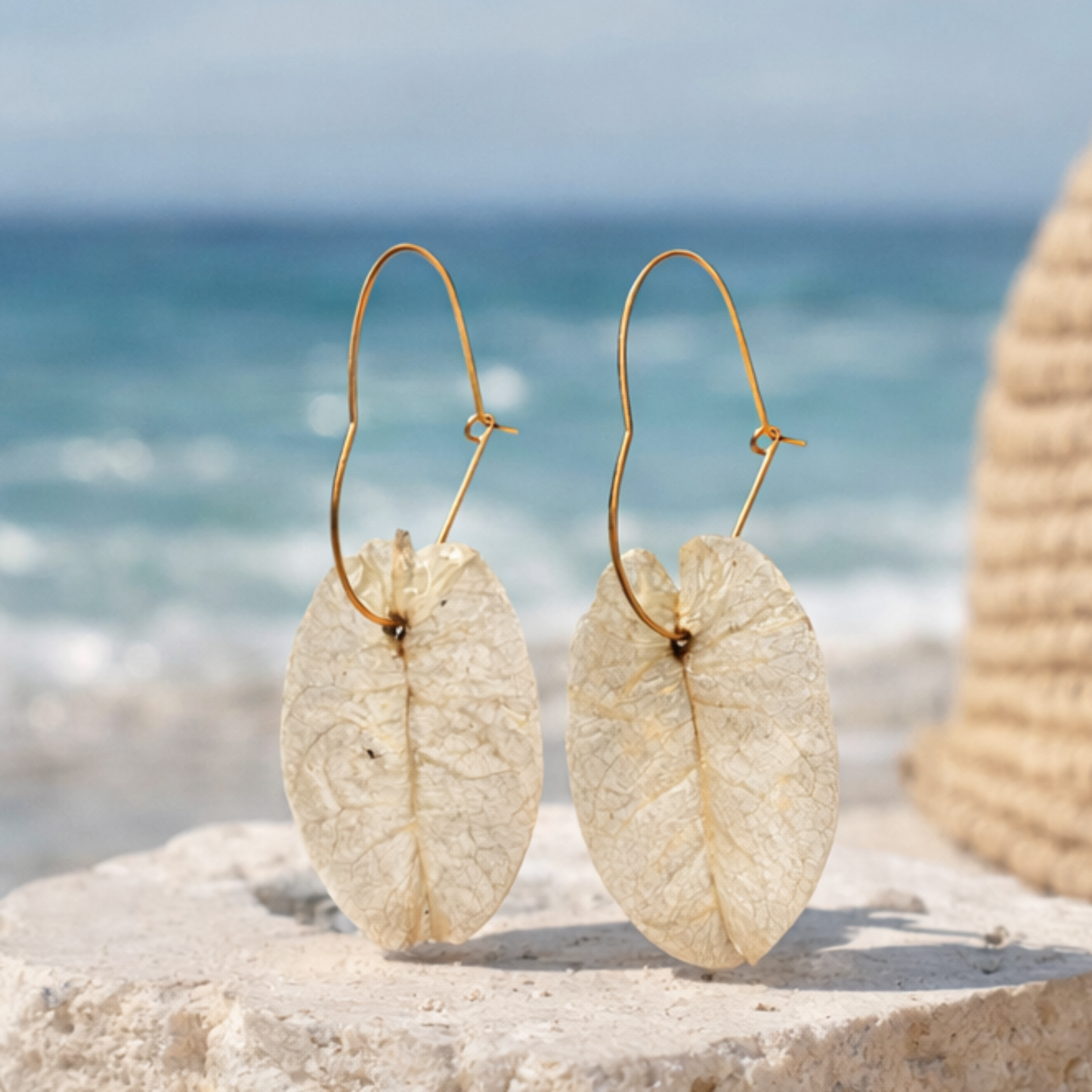 Ibiza Bridal earrings on a beach with ocean view