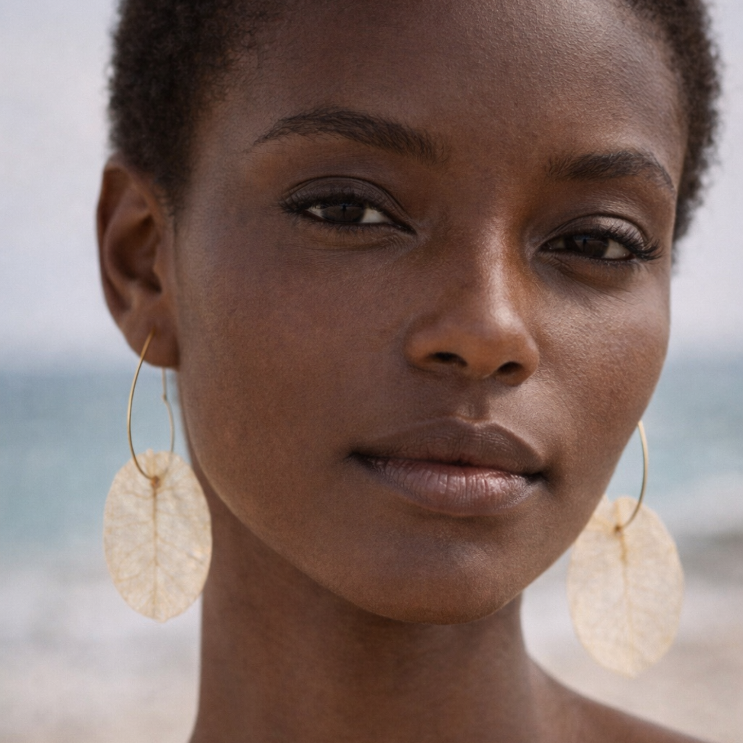 Bohemian model wearing white flower heart hoop earrings, lightweight artisan bridal jewellery.
