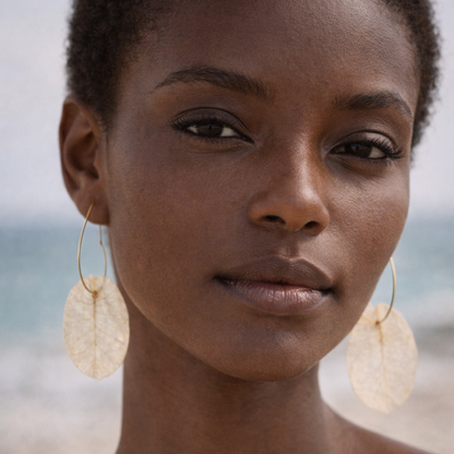 Bohemian model wearing white flower heart hoop earrings, lightweight artisan bridal jewellery.